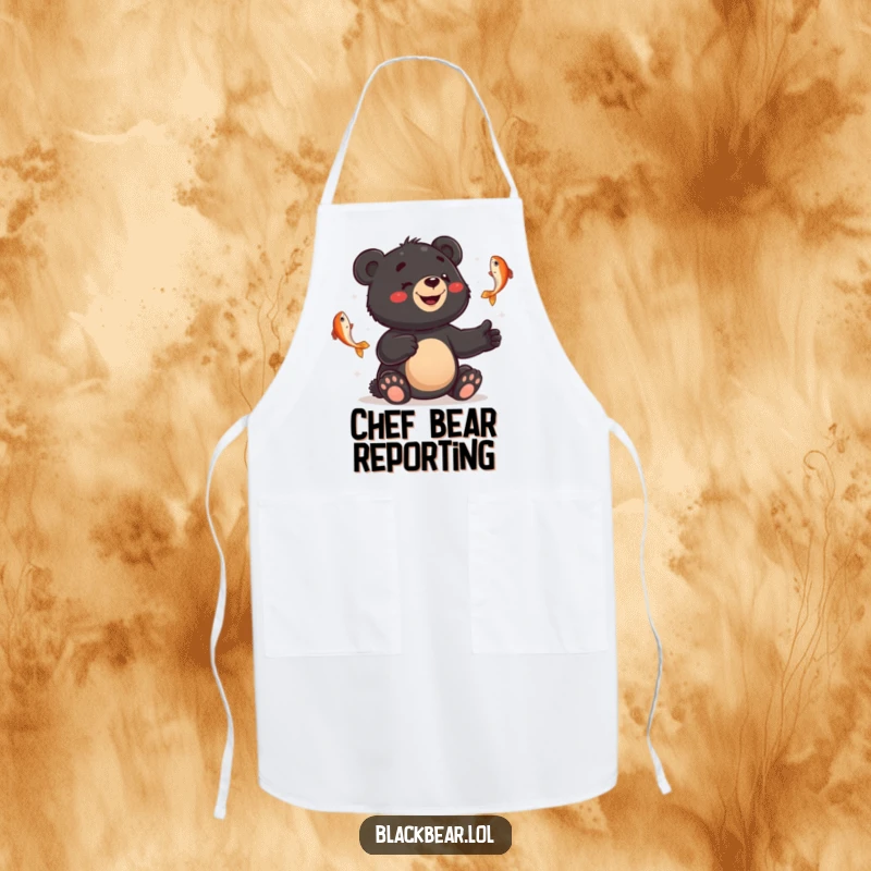 Funny apron showing a smiling black bear cub juggling fish with a bewildered expression, bringing humor to cooking.