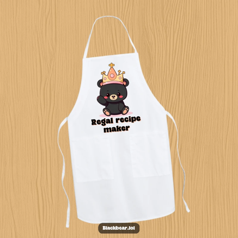 Funny apron featuring a black bear cub trying on a ridiculously oversized princess hat while cooking.