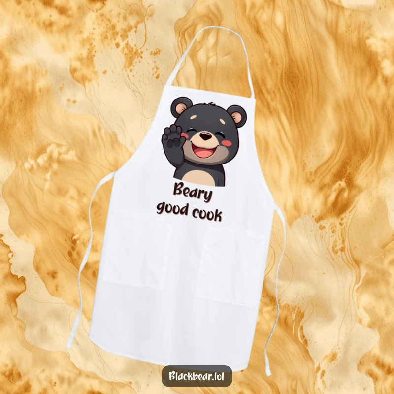 Funny black bear apron showing a happy black bear chef waving its paw with a wide grin, adding humor to cooking.