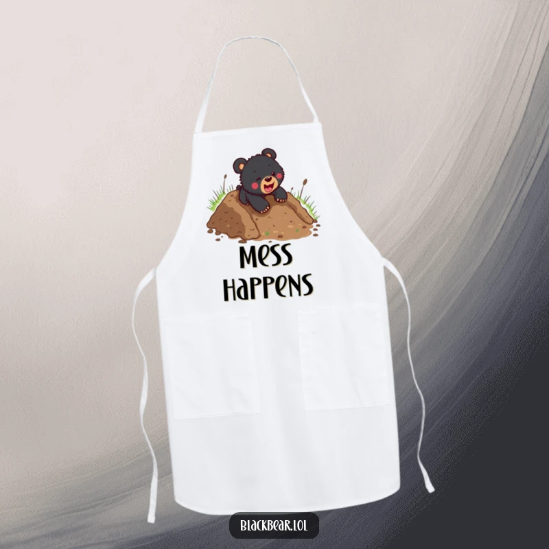 Funny black bear cub mid-slide down a muddy slope, wearing an apron, ready for kitchen adventures and a bit of mess.