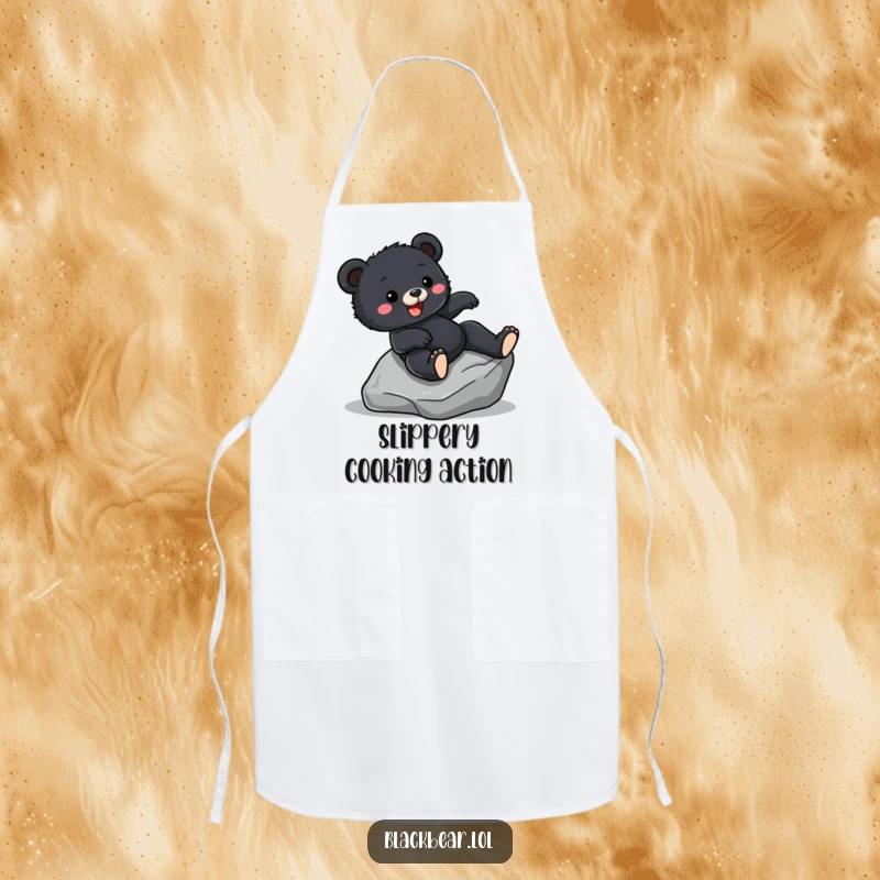 Funny Apron print of a black bear cub hilariously sliding down a rock, ideal for kitchen adventure and humor.