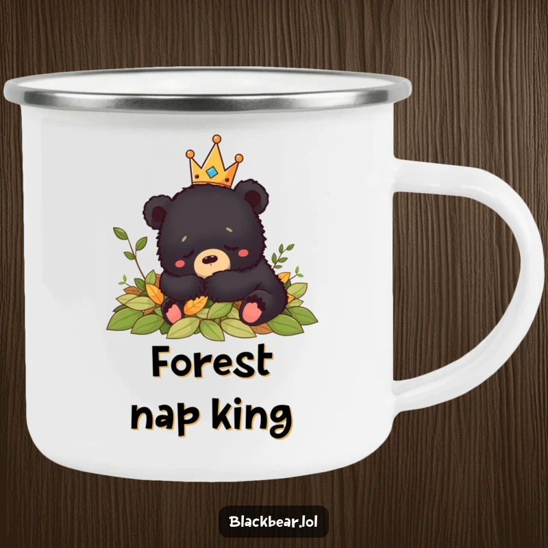 Funny crowned black bear cub napping peacefully in leaves, perfect for quiet moments on this camping mug.