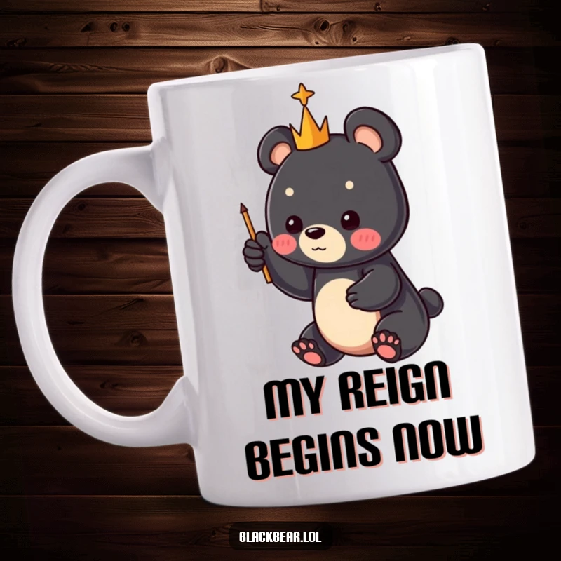Funny black bear cub with a tiny scepter, pointing joyfully to the sky, on a ceramic mug, perfect for a funny gift.