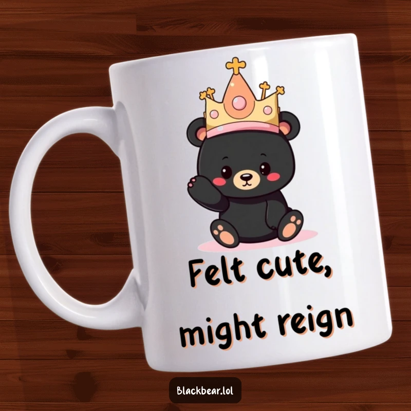 Funny mug shows a cute black bear cub hilariously trying on a comically oversized, sparkly princess hat.