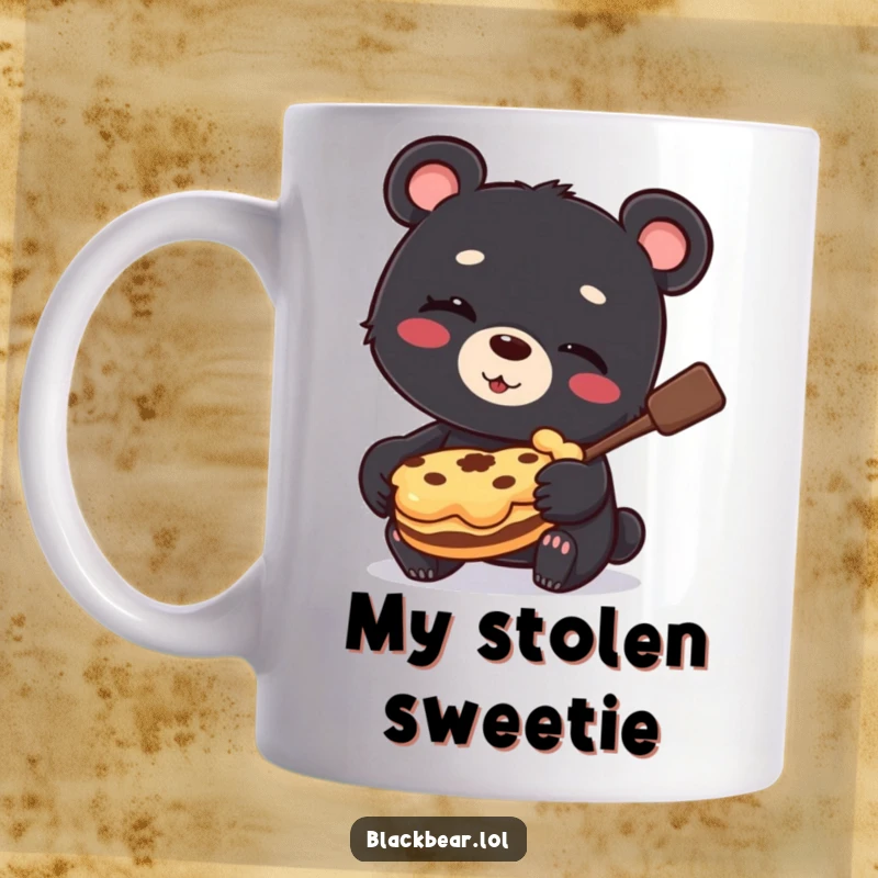 Funny Mug showing a black bear cub winking slyly while holding a large, stolen pie, crumbs on its face.