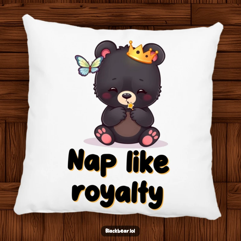 Funny pillow featuring a black bear cub in a tiny crown, playfully swatting at a butterfly, adding a touch of regal whimsy.