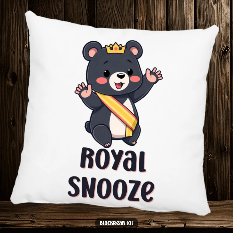 Funny black bear cub pillow wearing a sash, giving a mock royal wave, soft and regal comfort.