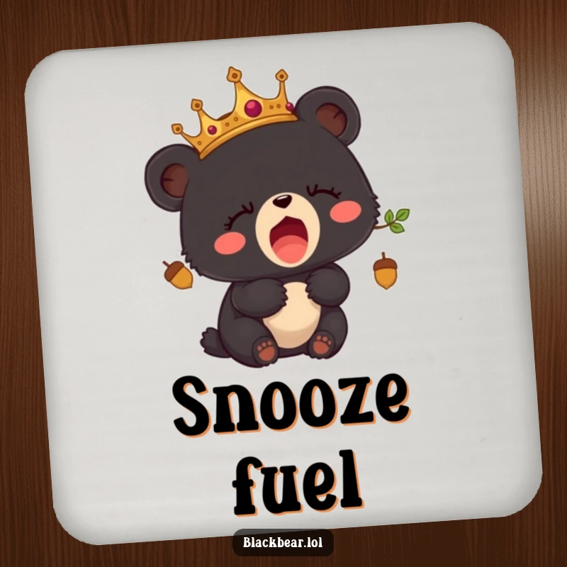 Funny drink coaster featuring a sleepy black bear cub wearing an acorn crown and yawning.