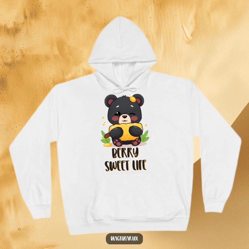 Funny Hoodie: A cute black bear cub winks cheekily, holding a large honeycomb, designed for warmth and delightful, humorous charm.