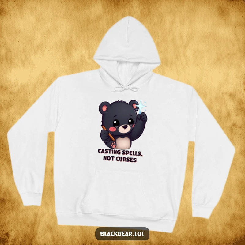 Funny black bear cub with big curious eyes reaching for a sparkling wand, depicted on a cozy hoodie for magical warmth.
