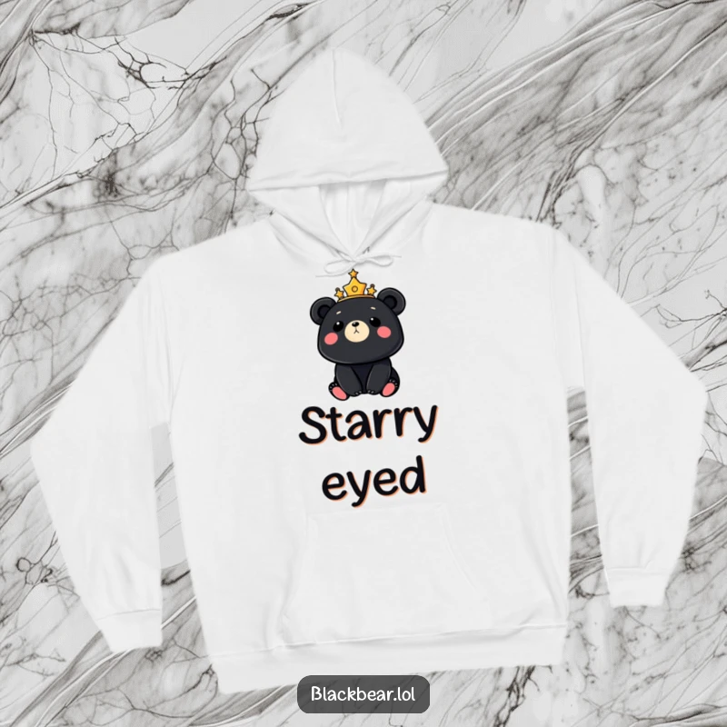 Cozy hoodie depicting a black bear adorned with a crown of stars, looking up at the moon, perfect for stargazing nights.