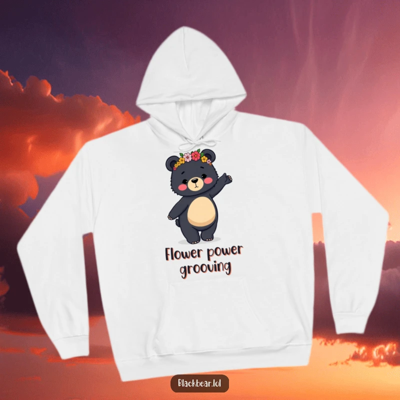 Funny hoodie depicting a black bear in a flower crown doing a clumsy but graceful dance, perfect for cozy fun.