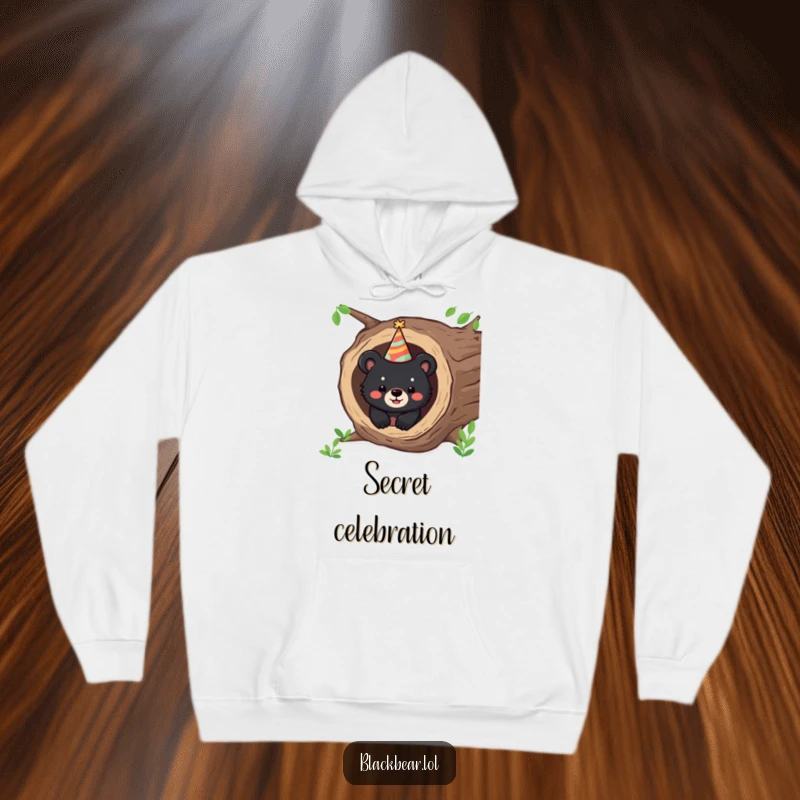 Funny hoodie featuring a happy bear cub peeking from a hollow log wearing a party hat, perfect for cozy celebrations.