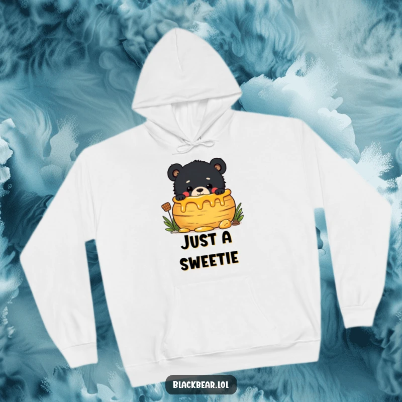 Funny hoodie print of a mischievous black bear cub peeking out from behind a large honey pot, craving sweet goodness.