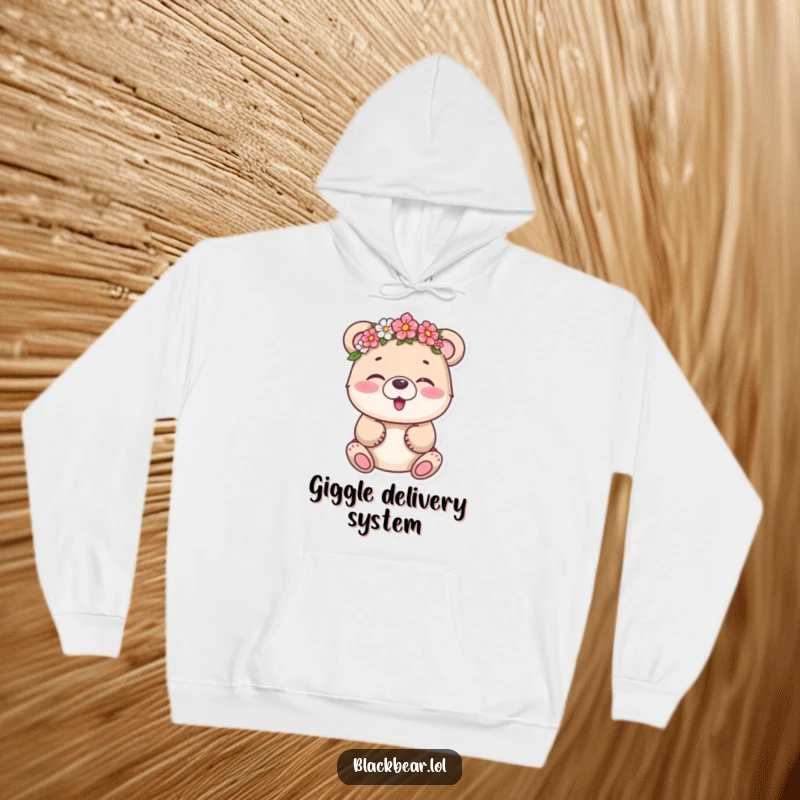 Funny bear cub wearing a flower crown askew, captured mid-giggle, on a soft hoodie, offering warmth and humor.
