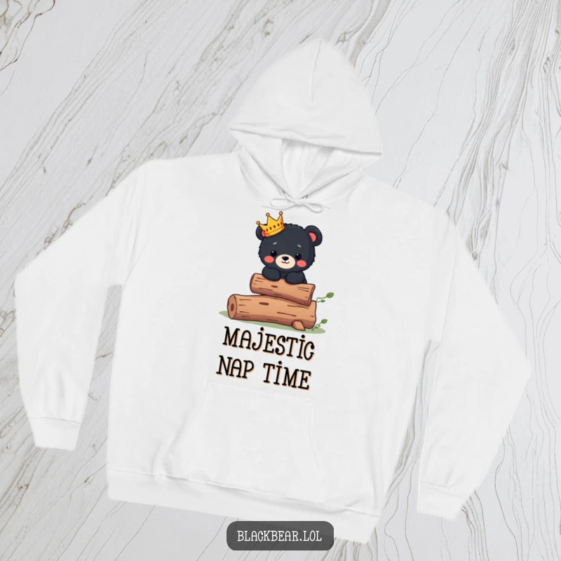 Funny Hoodie: Cute black bear cub wearing a tiny crown balances on a log, embodying regal comfort.
