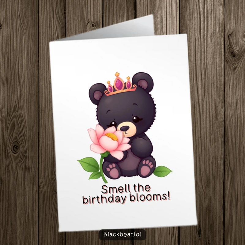 Funny Free Printable Birthday Card: Black bear cub wearing a tiara sniffs a giant flower happily.
