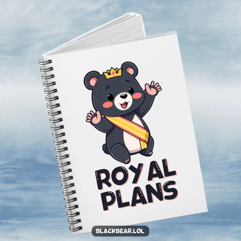 Funny black bear cub notebook wearing a sash, giving a mock royal wave, for regal note-taking.