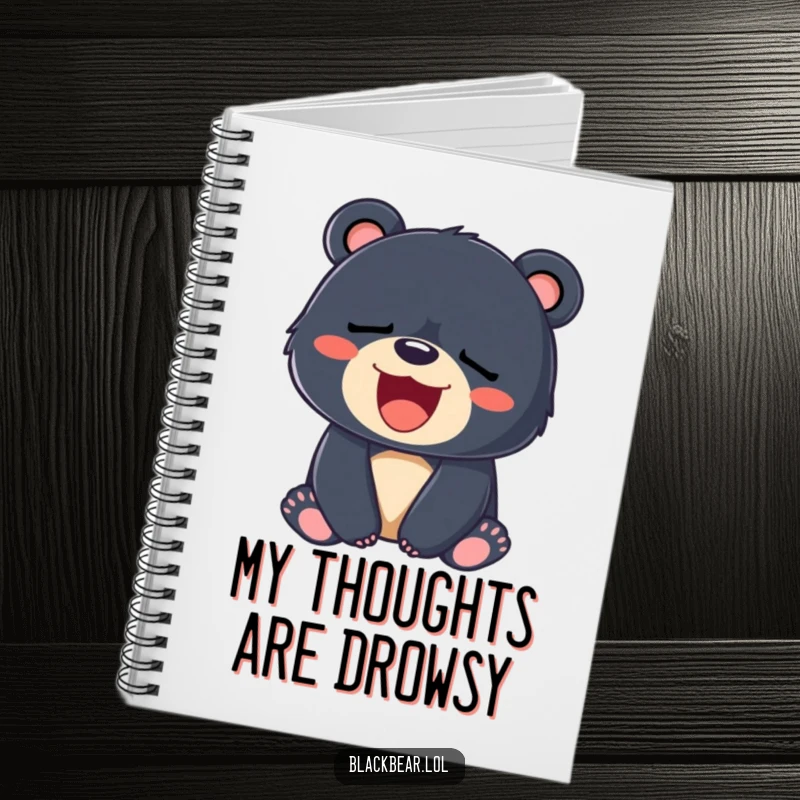 Funny notebook cover with a sleepy black bear cub yawning a big, happy smile, symbolizing rest and ideas.