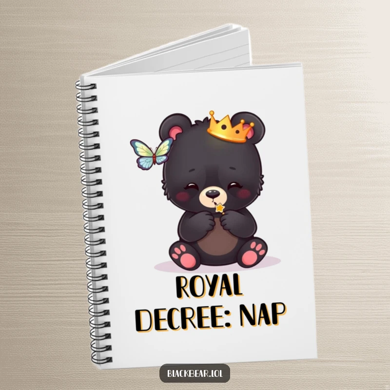 Funny notebook cover featuring a black bear cub adorned with a tiny crown, playfully chasing a butterfly, perfect for jotting notes.
