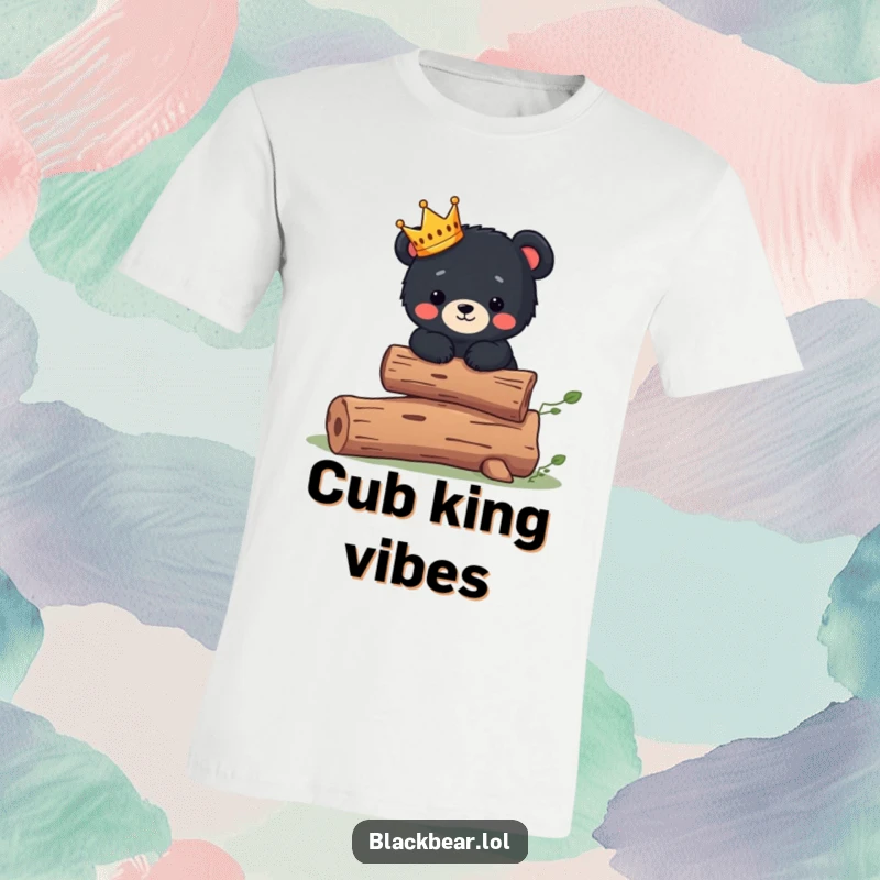 Funny T-Shirt: Cute black bear cub wearing a small crown balances expertly on a log, ruling the forest.