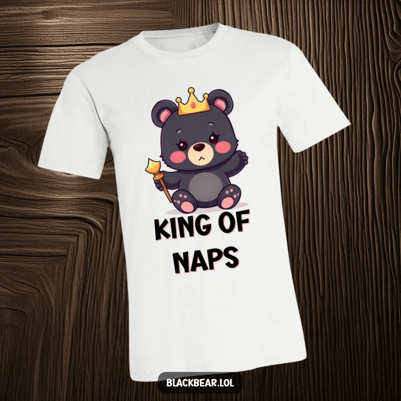 Funny t-shirt with a cute black bear cub wearing a small crown and holding a shiny scepter, embodying regal charm.
