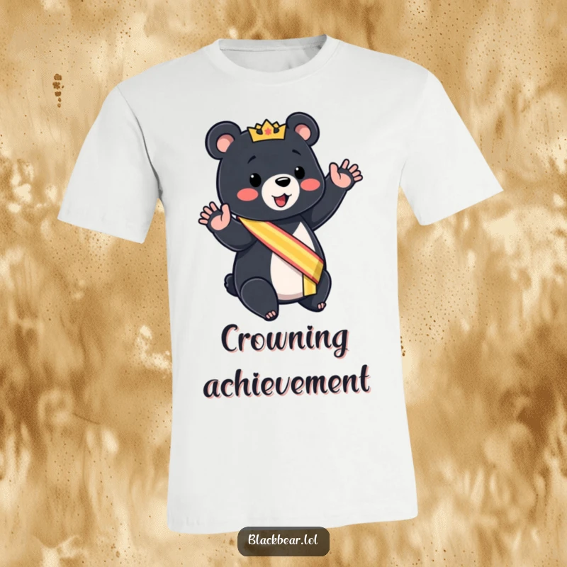 Funny black bear cub t-shirt wearing a sash, giving a mock royal wave, a regal graphic tee.