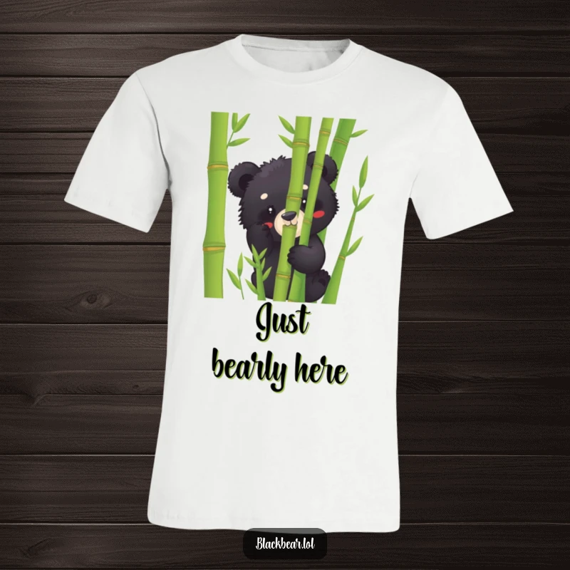 Funny black bear cub t-shirt peeking playfully from behind lush bamboo stalks, embodying curiosity and lighthearted fun.