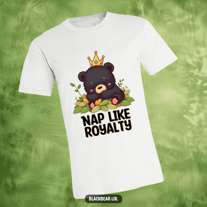 Funny black bear cub royalty in a crown peacefully naps in a pile of leaves on this cozy t-shirt.