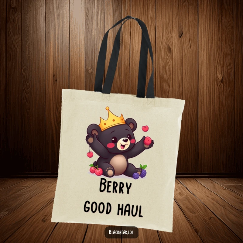 Funny Bear Cub Tote Bag: Charming black bear cub with a crown playfully juggles berries, carrying delight and skillful fun.
