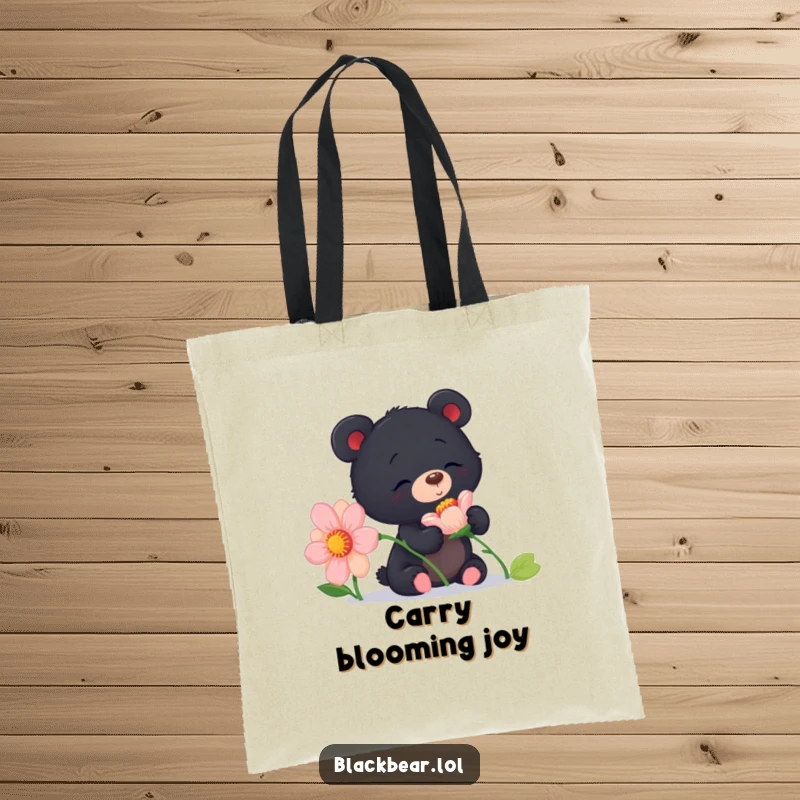 Funny curious black bear cub tote bag sniffing a giant flower, perfect for carrying items with a floral and humorous theme.