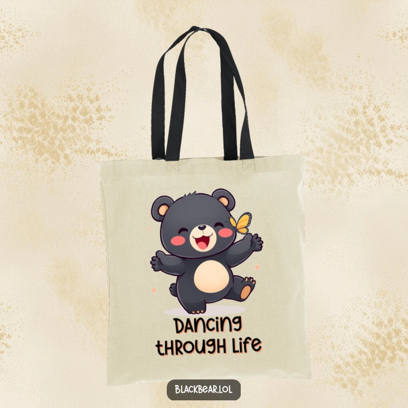 Funny tote bag showcasing a black bear cub doing a happy dance with a butterfly, perfect for carrying joy.