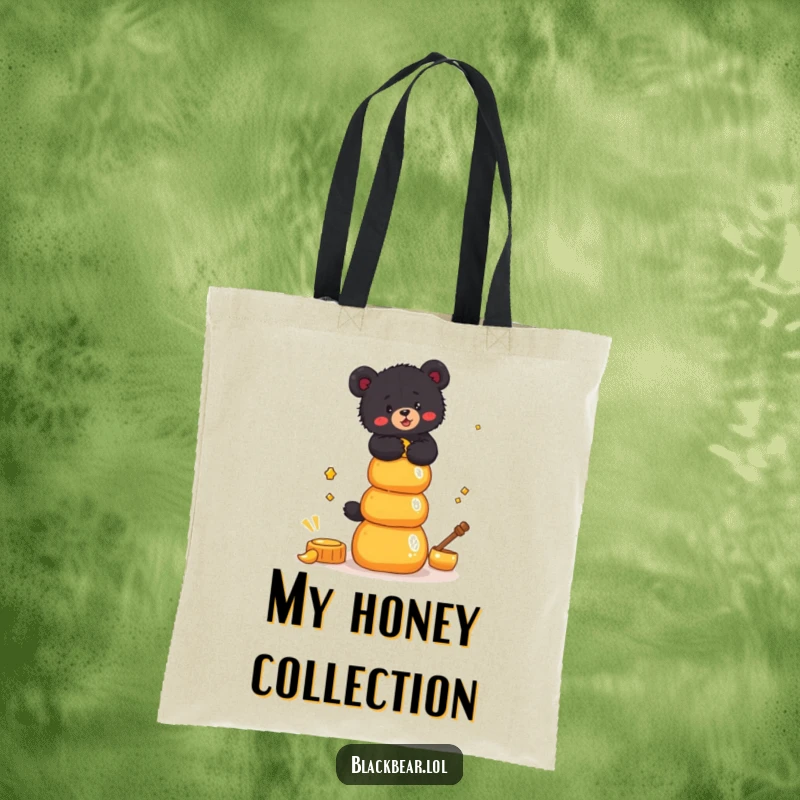 Funny Tote Bag print of a black bear cub attempting to balance a tall stack of honey pots, showcasing sweet ambition.