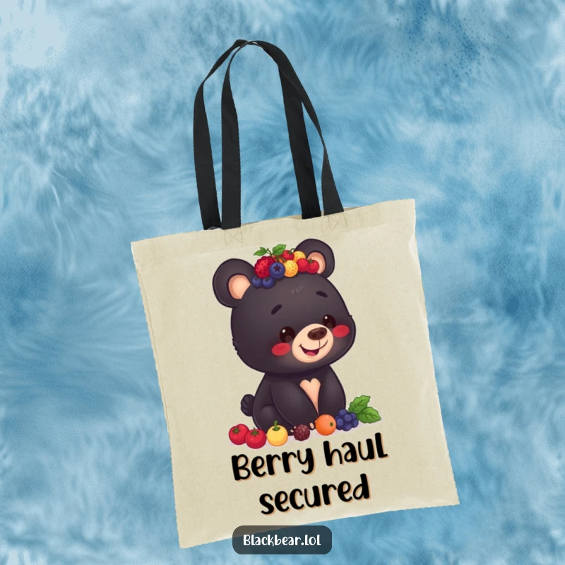 Funny tote bag illustration of a black bear cub with a big smile, balancing an impressive stack of berries on its head.