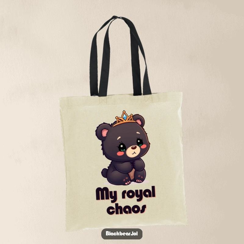 Funny black bear cub tote bag with a tiara askew, looking confusedly delighted, for carrying happy moments.