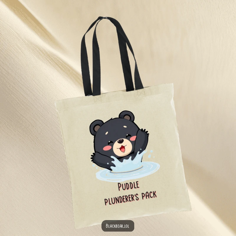 Funny Tote Bag: A black bear enthusiastically splashes in a puddle, perfect for carrying groceries or gear.